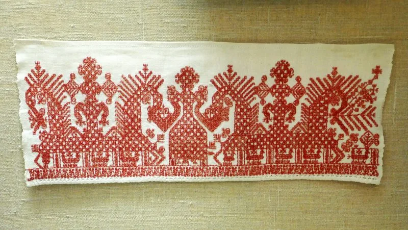 Broderie traditionnelle russe exposee au musee de Valday, motifs rouges sur tissu blanc